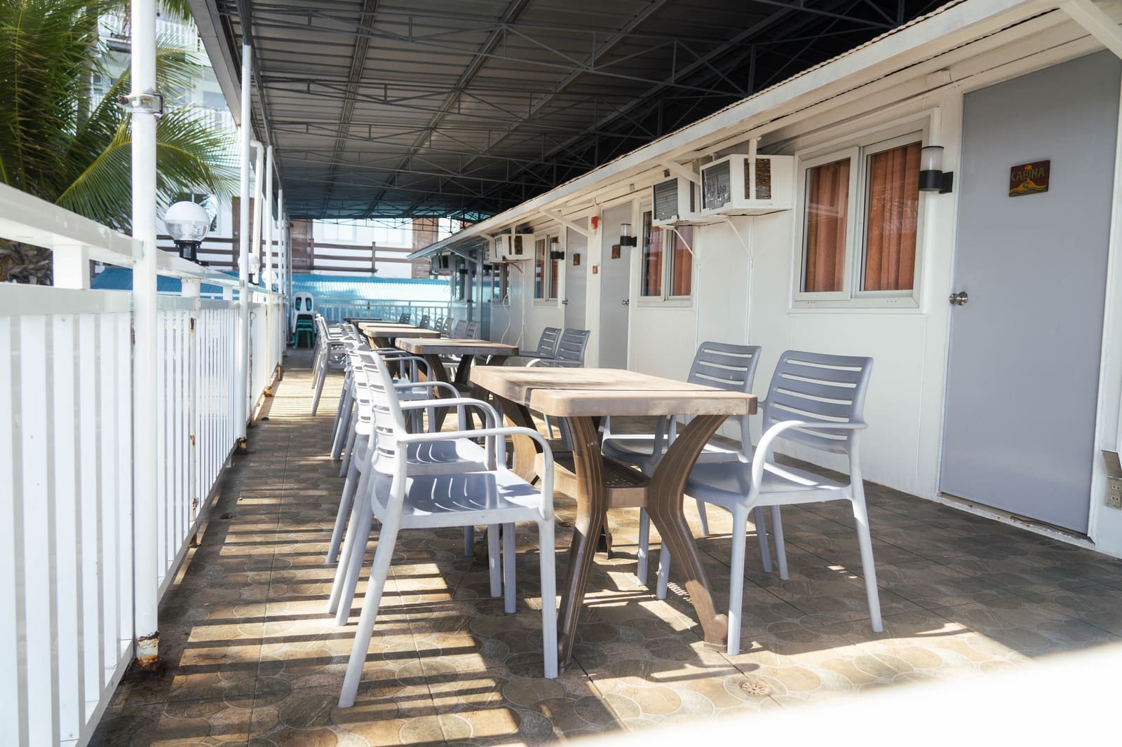 Covered terrace outside the air-conditioned cabina rooms at Isola Vista Beach Resort