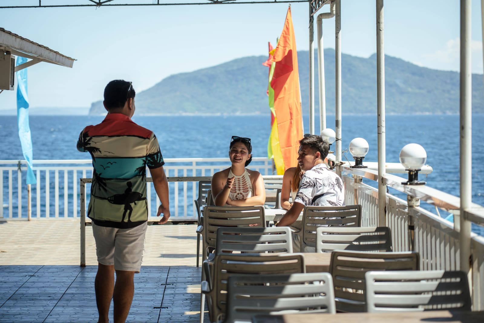 Seaside terrace dining with island view at Isola Vista Beach Resort